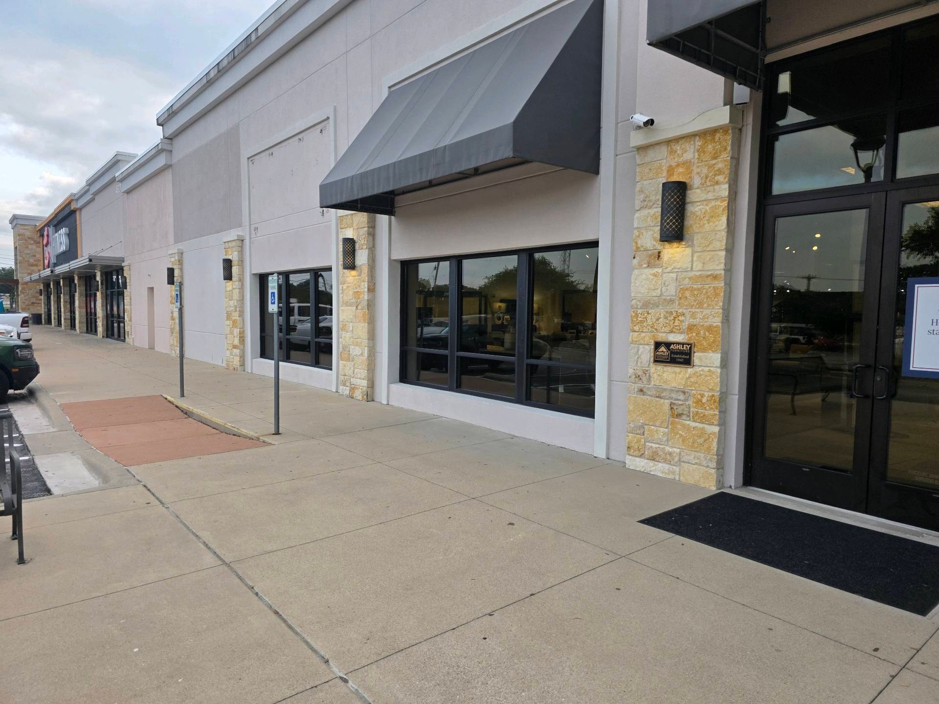Commercial storefront after pressure washing — clean facade and sidewalk